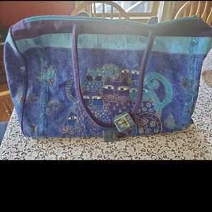 Vibrant Blue and Purple Travel Bag with Whimsical Patterns